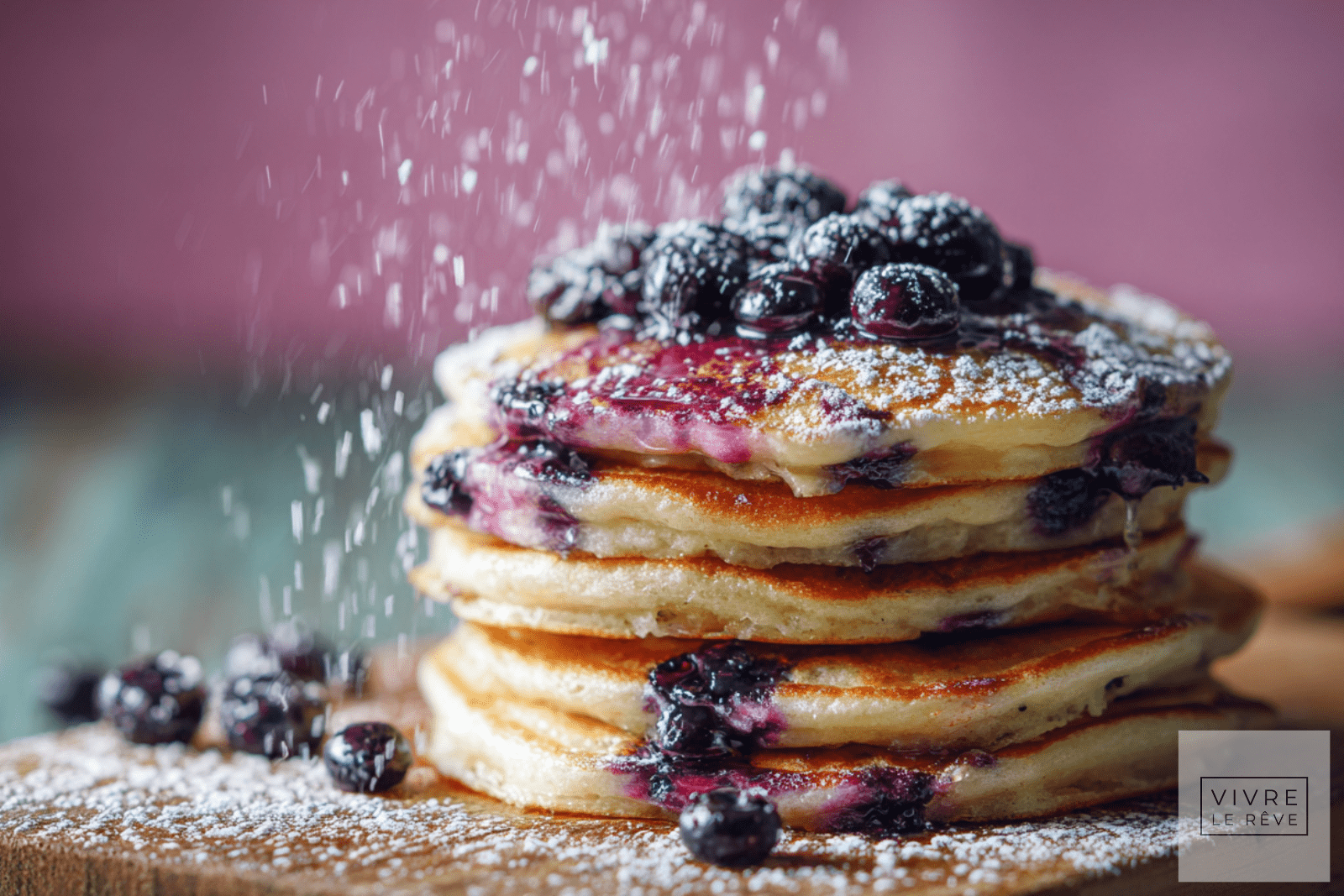 Super Simple Delicious Blueberry Pancakes dusted with icing sugar.