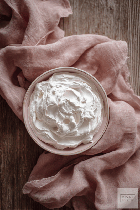 Overhead picture of whipped cream in a bowl showing How to Make Perfect Whipped Cream Every Time.